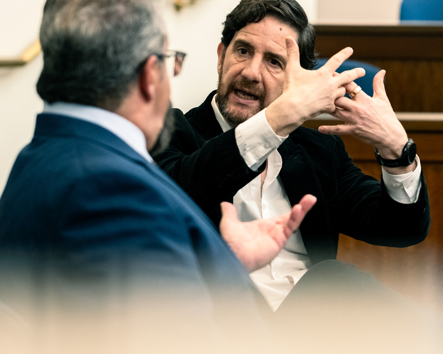 Photograph from an academic event showing two experts in dialogue