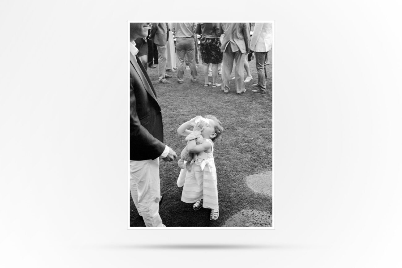 Black and White Photograph of of a small child drinking from a cup